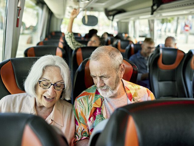Senior couple traveling on a tour bus