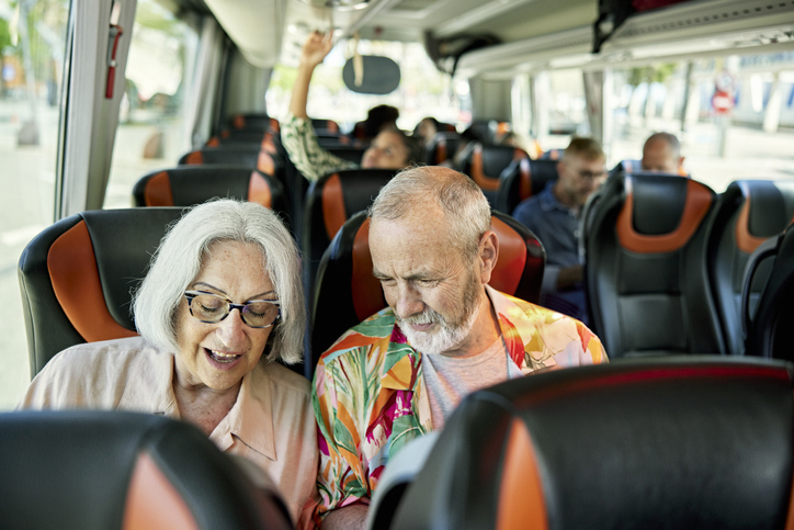 Senior couple traveling on a tour bus
